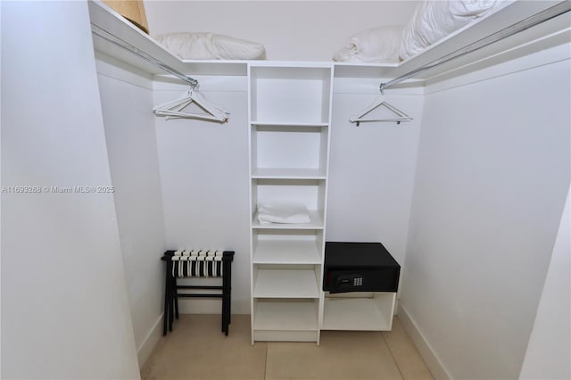 spacious closet with light tile patterned flooring