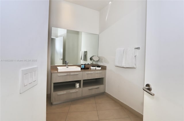 bathroom featuring tile patterned flooring, vanity, and baseboards