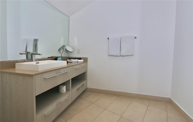 bathroom featuring tile patterned flooring, baseboards, and vanity