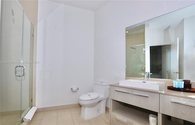 bathroom featuring toilet, vanity, baseboards, a shower stall, and tile patterned floors