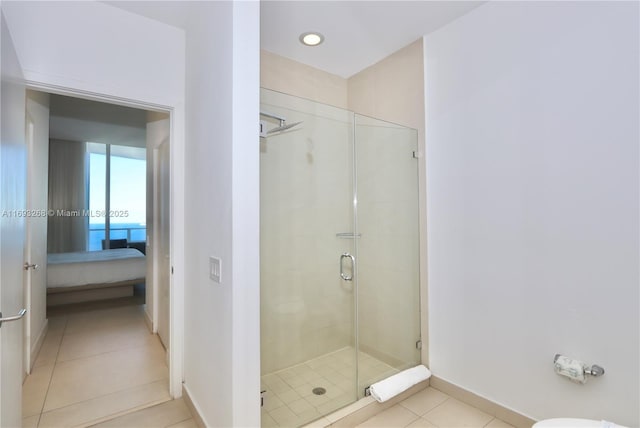 full bath with ensuite bathroom, recessed lighting, baseboards, tile patterned floors, and a stall shower