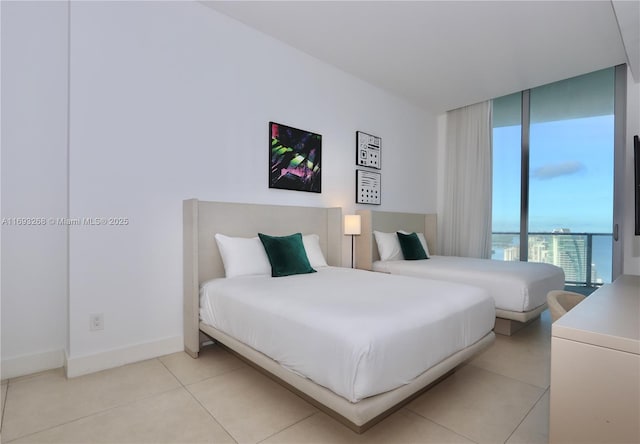 bedroom with light tile patterned floors and baseboards