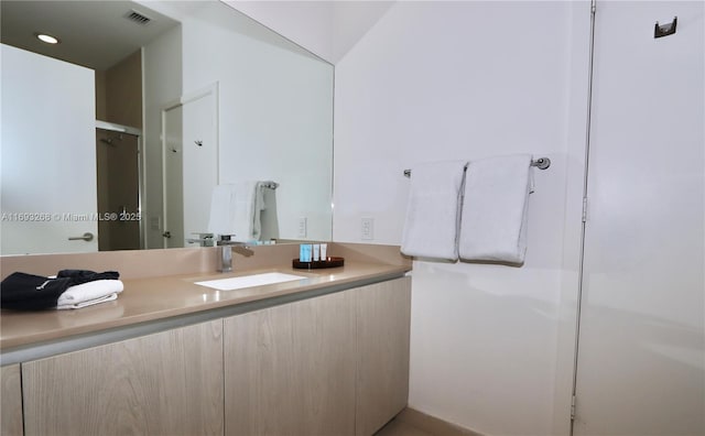 bathroom featuring recessed lighting, visible vents, and vanity