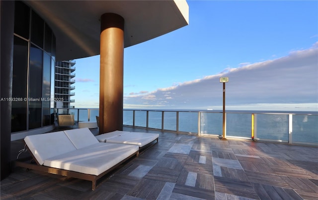 view of patio / terrace featuring a water view and a balcony