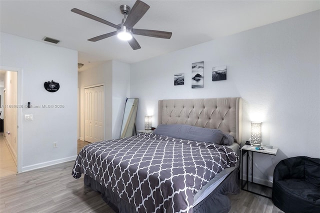 bedroom with wood-type flooring, a closet, and ceiling fan