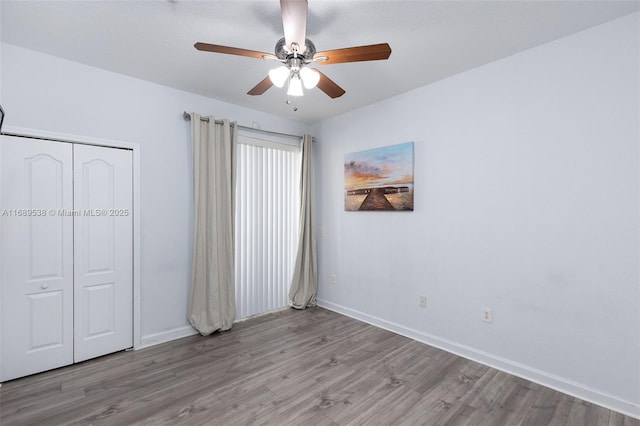 unfurnished bedroom featuring light wood-type flooring, a closet, and ceiling fan