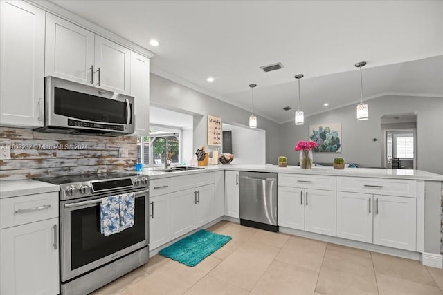 kitchen featuring stainless steel appliances, white cabinetry, backsplash, pendant lighting, and lofted ceiling