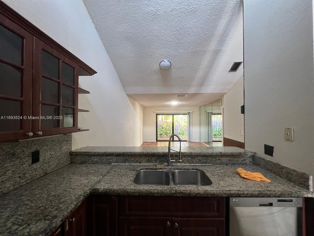 kitchen with sink, stainless steel dishwasher, a textured ceiling, and kitchen peninsula