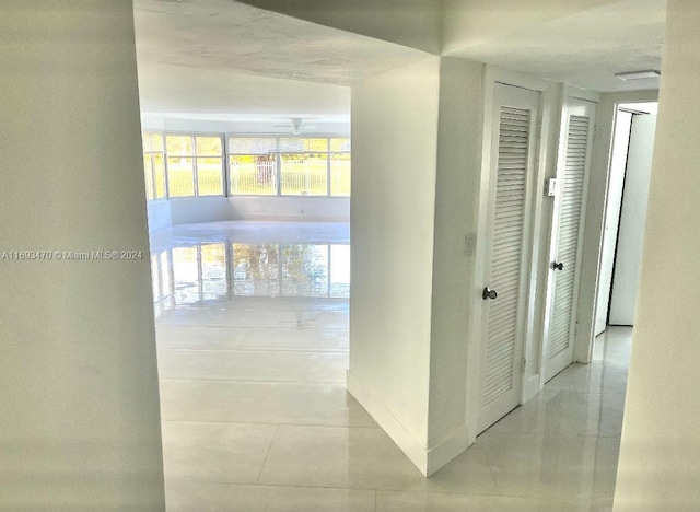 corridor featuring light tile patterned floors