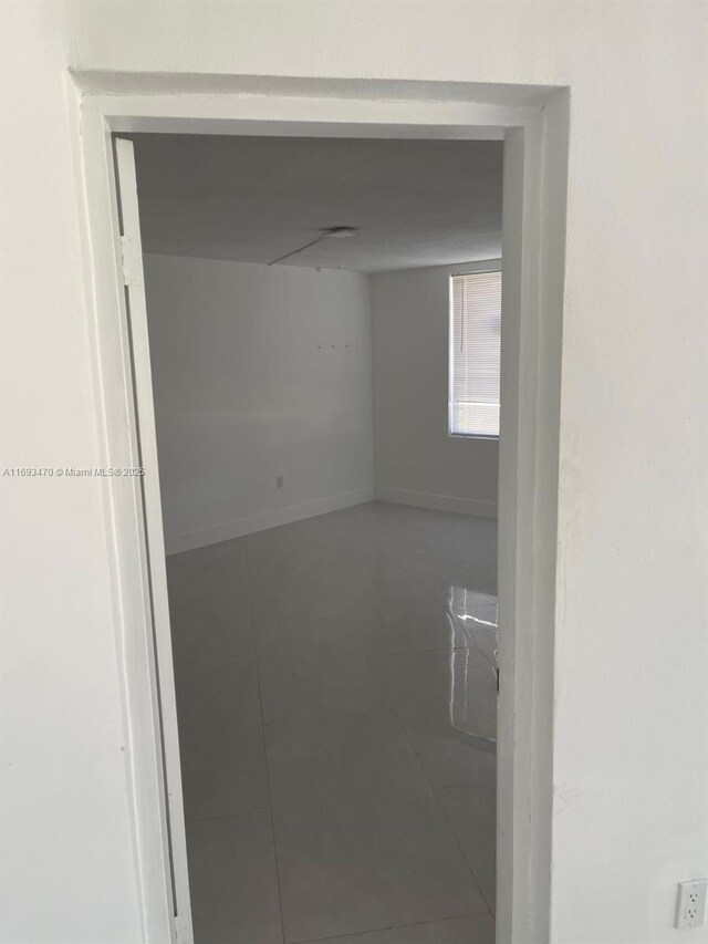 unfurnished room featuring tile patterned floors