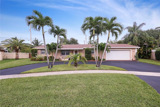 view of front of home with a garage and a front lawn