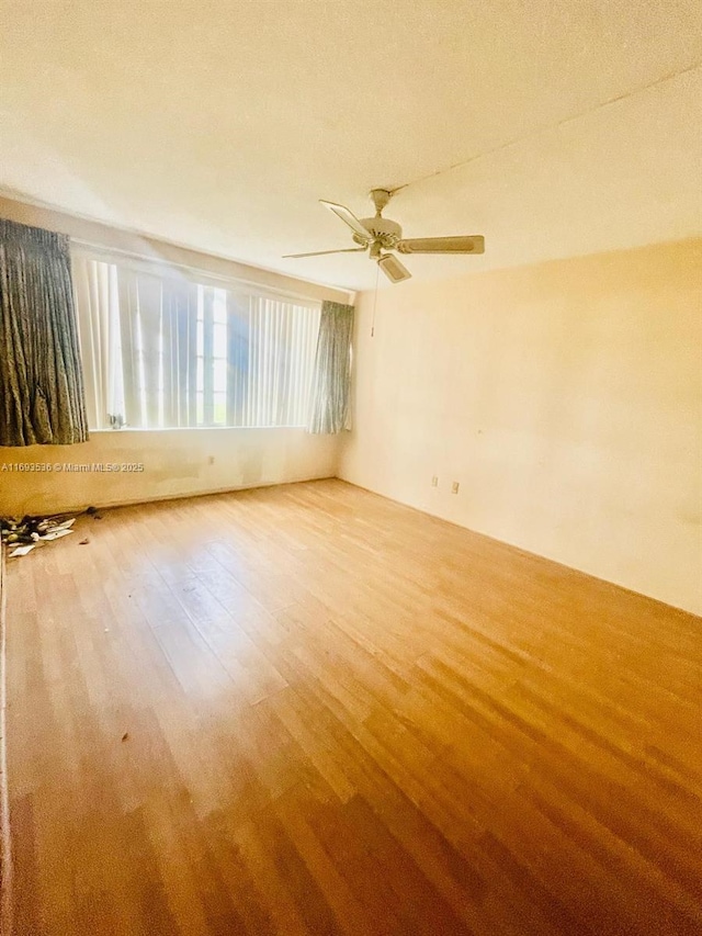 unfurnished room featuring ceiling fan and wood finished floors