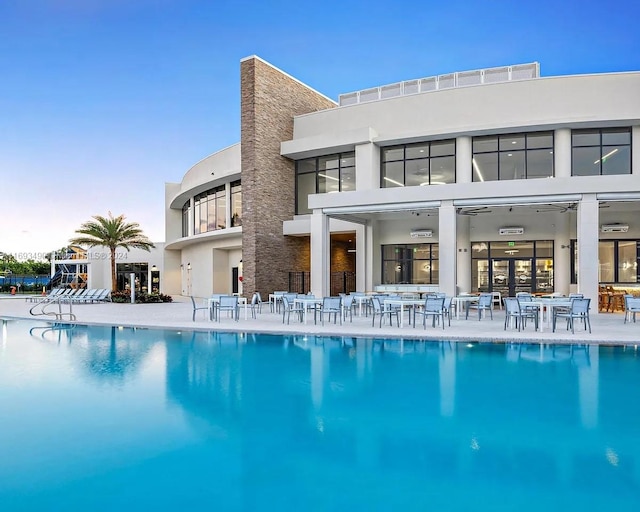 rear view of house featuring a community pool