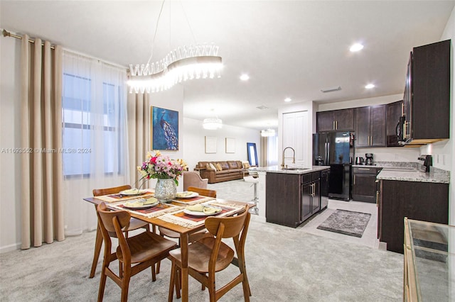 carpeted dining room with sink