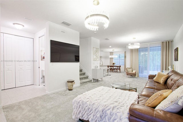 living room with light colored carpet and an inviting chandelier