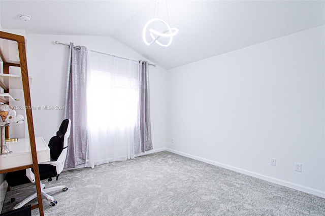 unfurnished office featuring carpet flooring, a chandelier, and vaulted ceiling