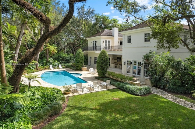 view of pool featuring a lawn and a patio area