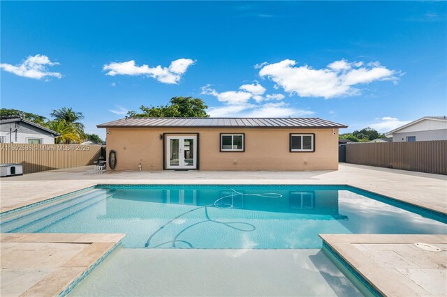 view of pool featuring french doors and a patio