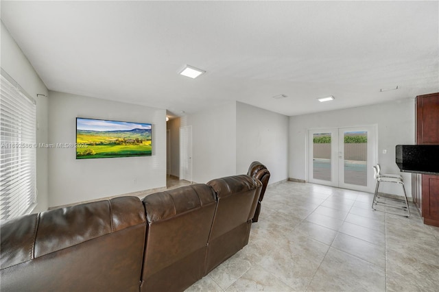 living area with french doors and light tile patterned flooring