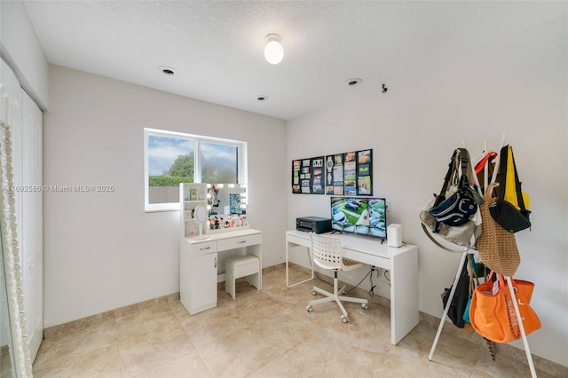 office with a textured ceiling and baseboards