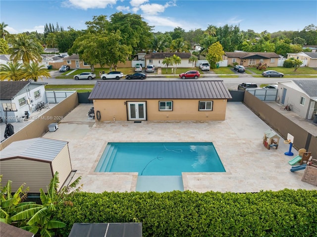 exterior space with a patio area, a fenced backyard, a residential view, and french doors