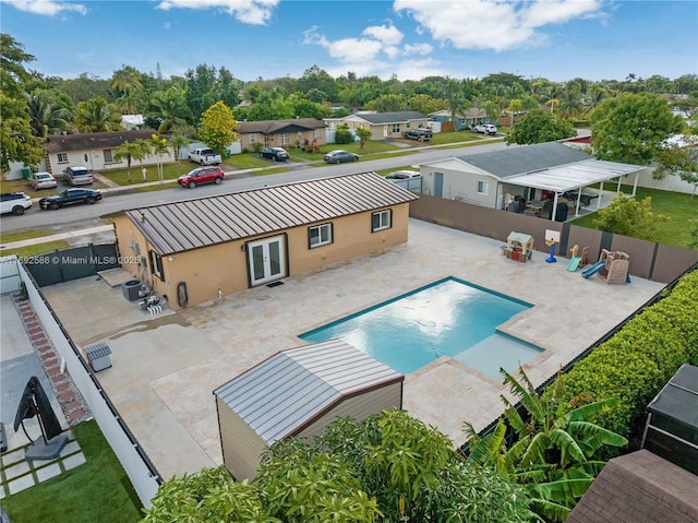 back of property with a patio, french doors, and a fenced backyard