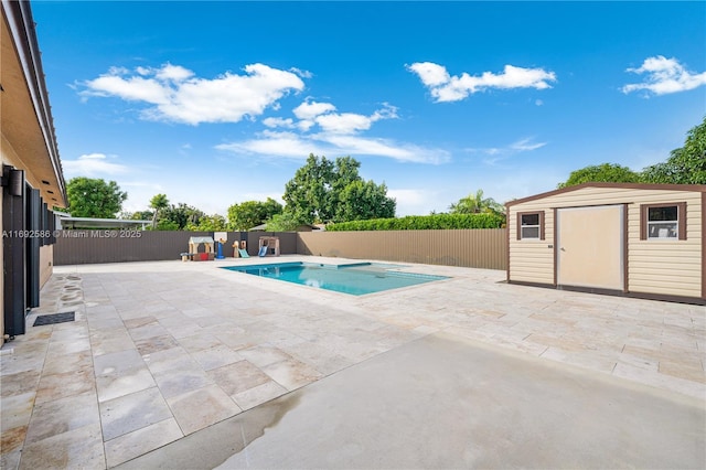 view of swimming pool with a patio, a fenced backyard, an outdoor structure, a fenced in pool, and a storage unit