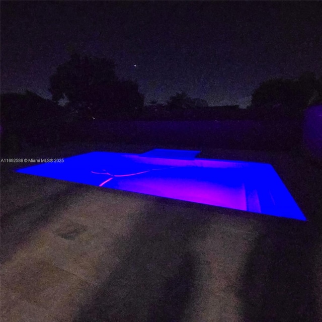 view of pool at night