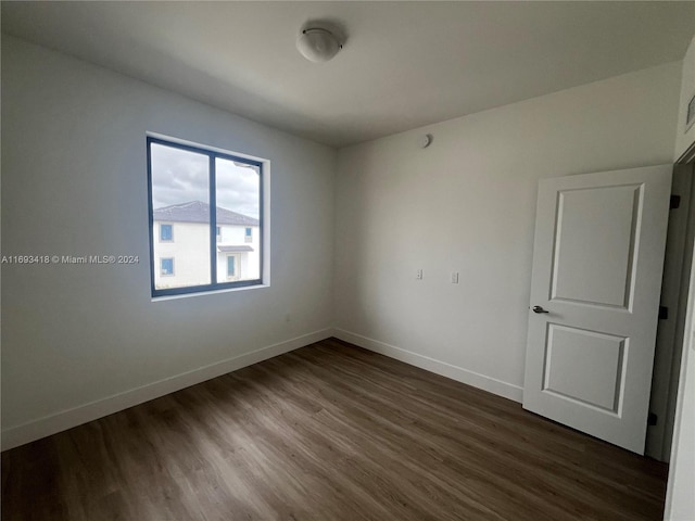 spare room featuring dark hardwood / wood-style flooring