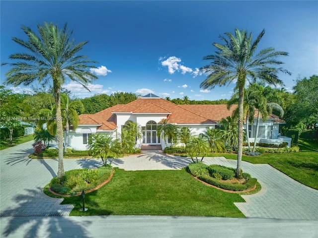 mediterranean / spanish-style home featuring a front lawn
