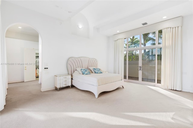 bedroom with access to exterior, arched walkways, carpet floors, baseboards, and recessed lighting