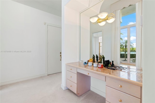 bathroom featuring vanity and a notable chandelier