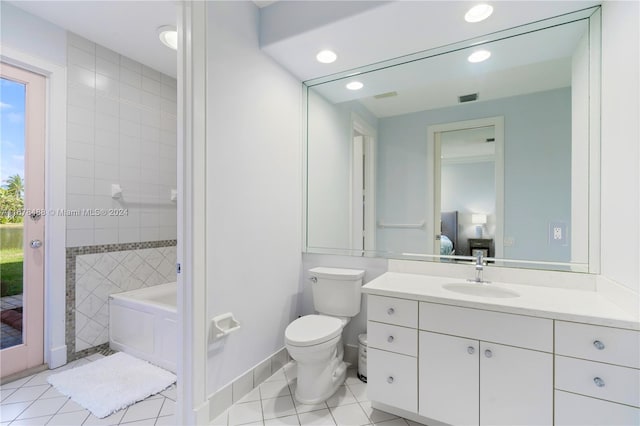 bathroom with a washtub, tile patterned flooring, vanity, and toilet