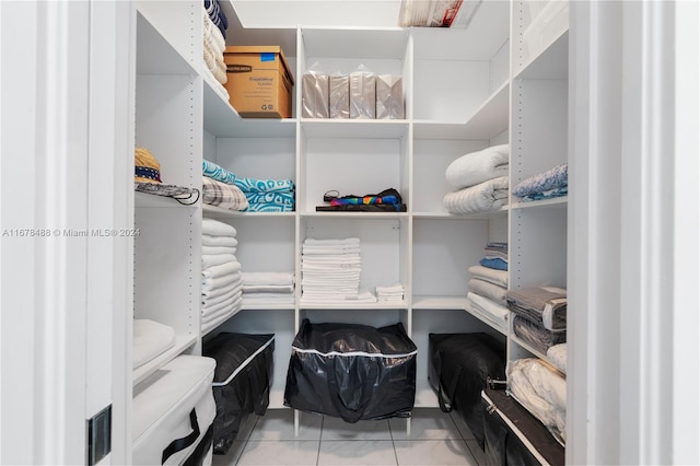 spacious closet featuring tile patterned flooring