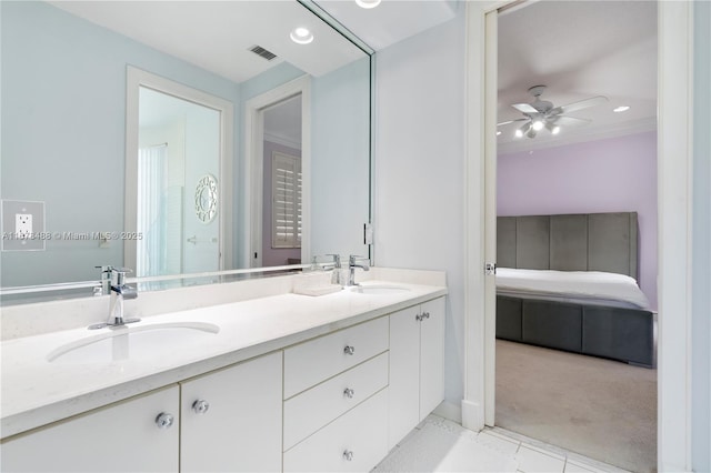 full bath with a sink, ceiling fan, double vanity, and visible vents