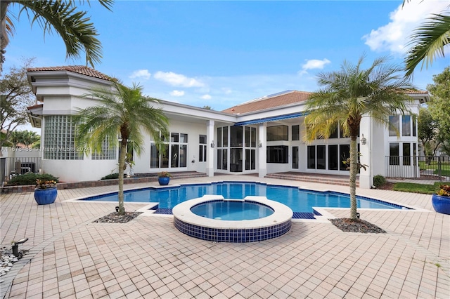 view of swimming pool featuring an in ground hot tub