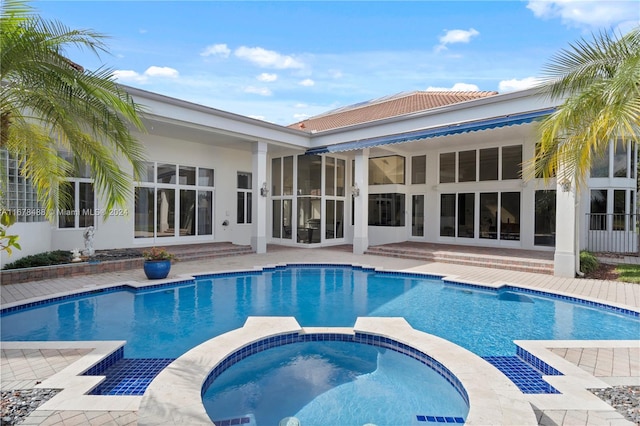 view of pool with a patio area and an in ground hot tub