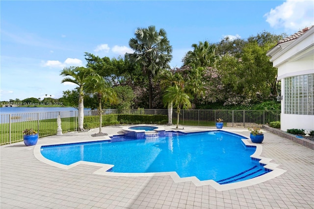view of swimming pool featuring a water view, a pool with connected hot tub, fence, and a patio