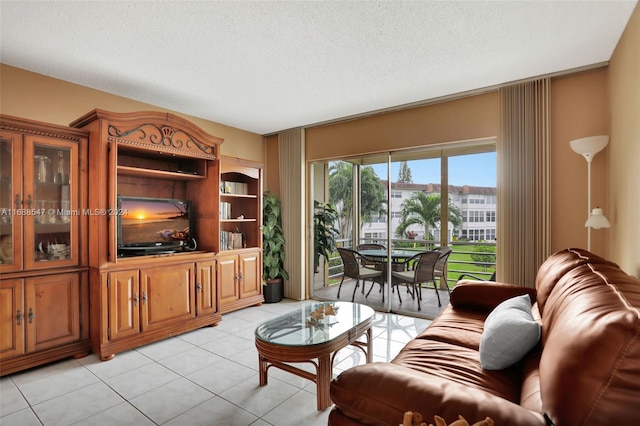 living room featuring light tile patterned floors and a textured ceiling