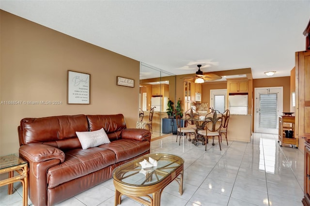 living room with ceiling fan and light tile patterned floors