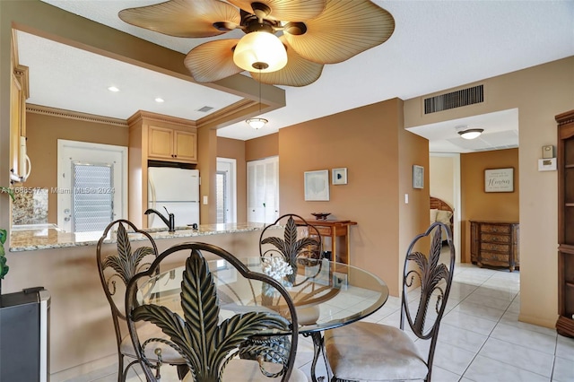 dining room with ceiling fan and light tile patterned floors