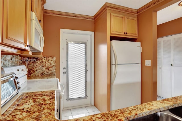 kitchen with white appliances, backsplash, and light tile patterned floors