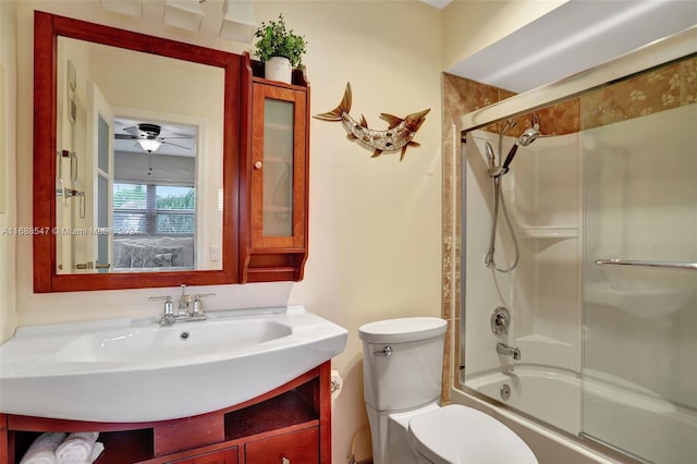 full bathroom featuring vanity, toilet, ceiling fan, and combined bath / shower with glass door