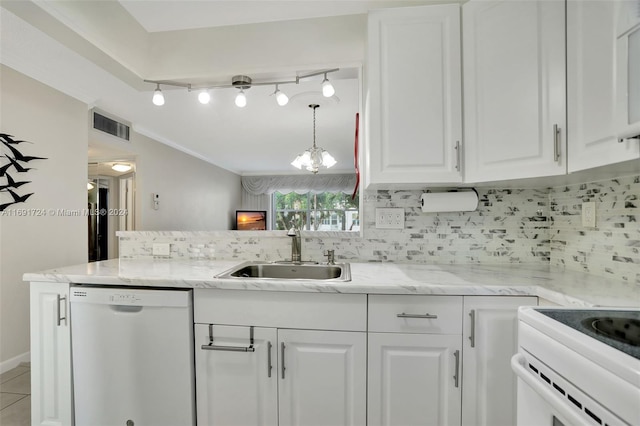 kitchen with tasteful backsplash, white dishwasher, sink, a notable chandelier, and white cabinets