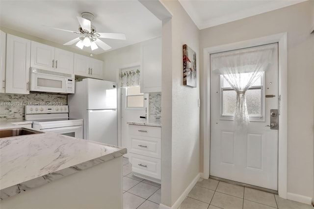 kitchen with backsplash, white appliances, ceiling fan, white cabinets, and light tile patterned flooring