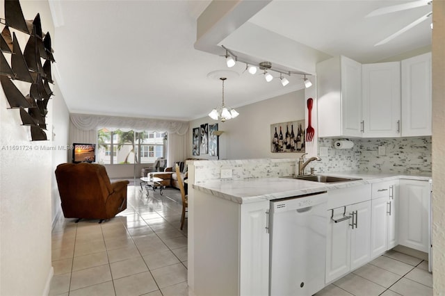 kitchen with white cabinets, sink, tasteful backsplash, kitchen peninsula, and dishwasher