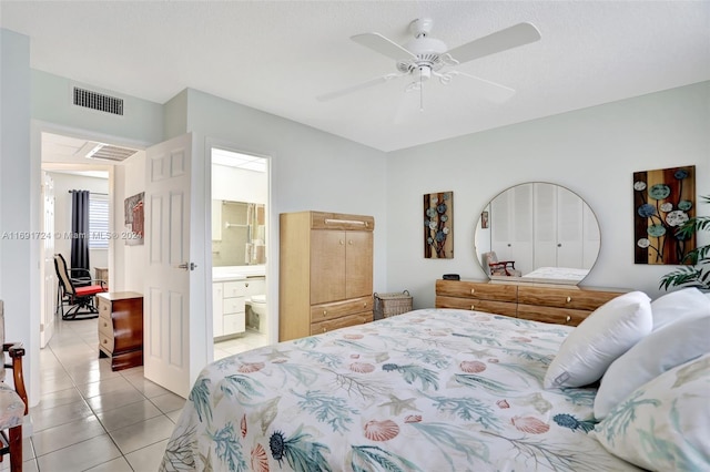 bedroom with ensuite bath, ceiling fan, and light tile patterned flooring