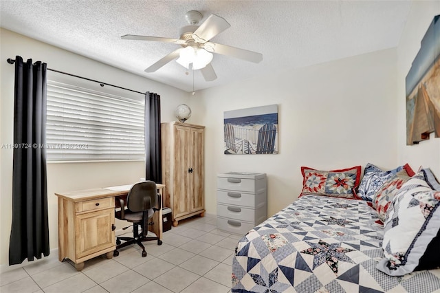 bedroom featuring a textured ceiling, ceiling fan, and light tile patterned flooring