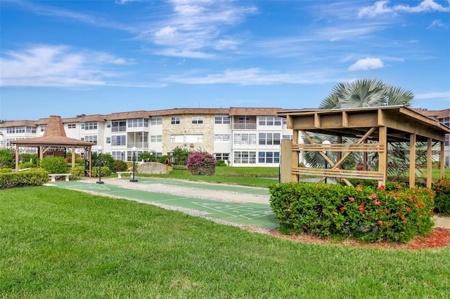 3501 NW 47th Ave Unit 515, Lauderdale Lakes, FL 33319 - view of home's community featuring a lawn, a gazebo, and shuffleboard