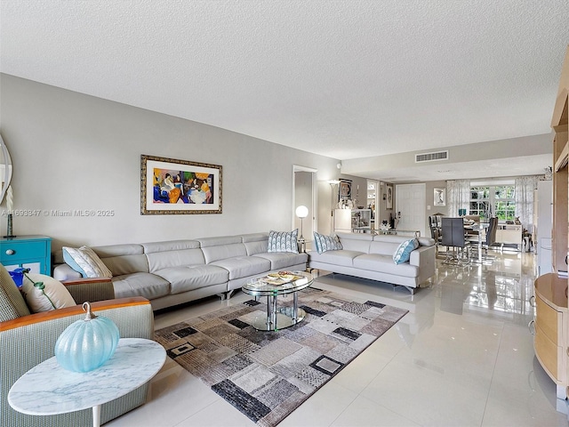 living room with light tile patterned floors and a textured ceiling